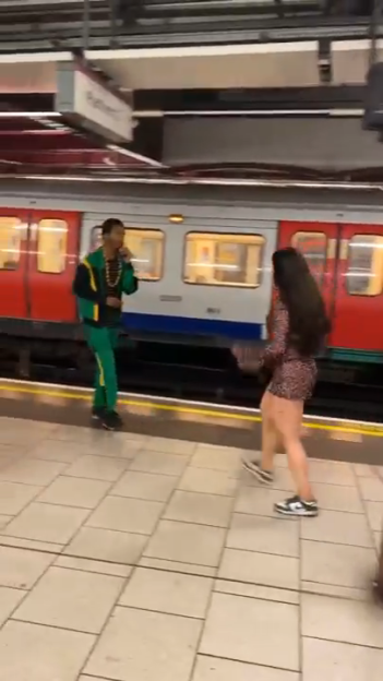 Two people arguing on a Tube station platform.