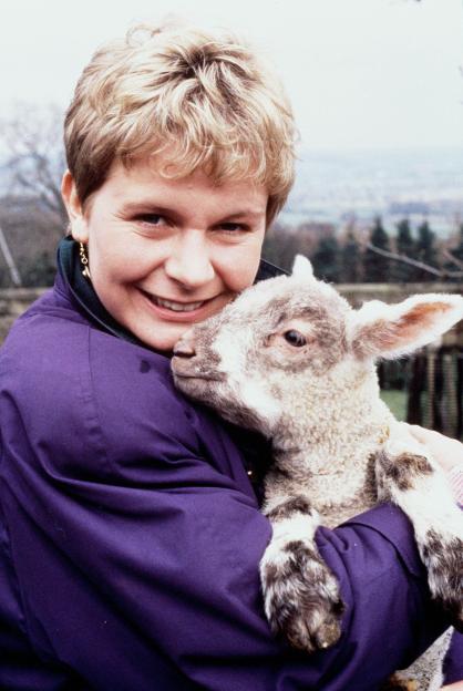 Photograph of Rachel Hughes from Emmerdale holding a lamb.