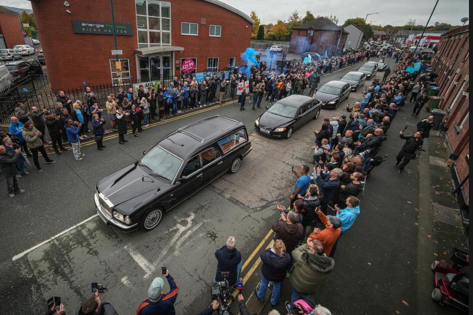 The funeral cortege of Ricky Hatton passes his boxing gym in his hometown of Hyde.