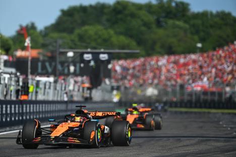 Two McLaren Formula 1 cars racing on a track.