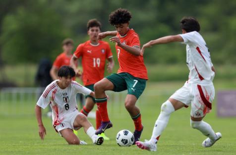 Portugal's U15 national football team player Cristiano Dos Santos (C), son of Cristiano Ronaldo, vies with Japan's Sakuto Fukaya (L) and Haru Tsushima (R) during a match between Portugal and Japan as part of the Vlatko-Markovic U15 youth tournament in Sveti Martin na Muri on May 13 2025. (Photo by DAMIR SENCAR / AFP) (Photo by DAMIR SENCAR/AFP via Getty Images)
