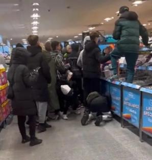Shoppers fighting over Prime energy drinks at Aldi.