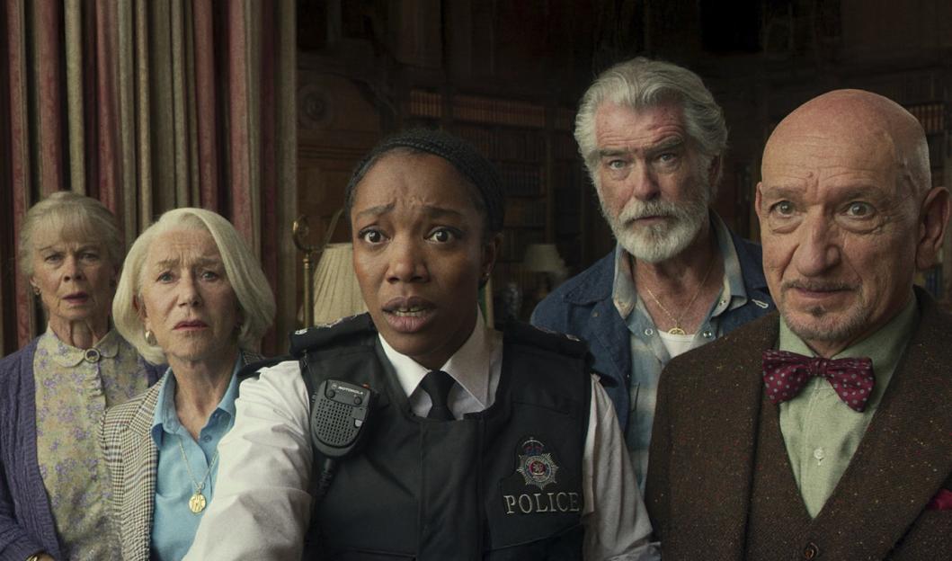 Scene from "The Thursday Murder Club" showing Celia Imrie, Helen Mirren, Naomi Ackie, Pierce Brosnan, and Ben Kingsley.