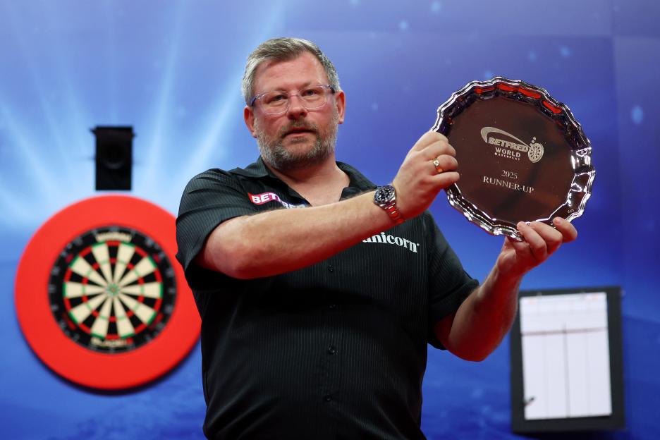 James Wade holding his 2025 World Matchplay runner-up plate.