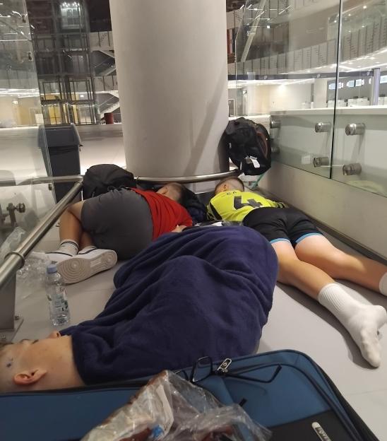 Three boys sleeping on the floor of Split Airport in Croatia.