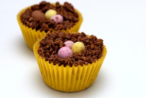 Two chocolate Easter nest cakes with mini eggs.