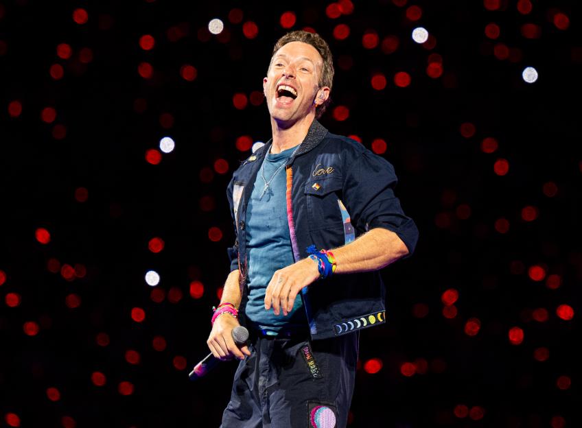 Chris Martin of Coldplay performs onstage at Wembley Stadium.