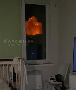 Video of a nighttime explosion seen through a window in a bedroom.