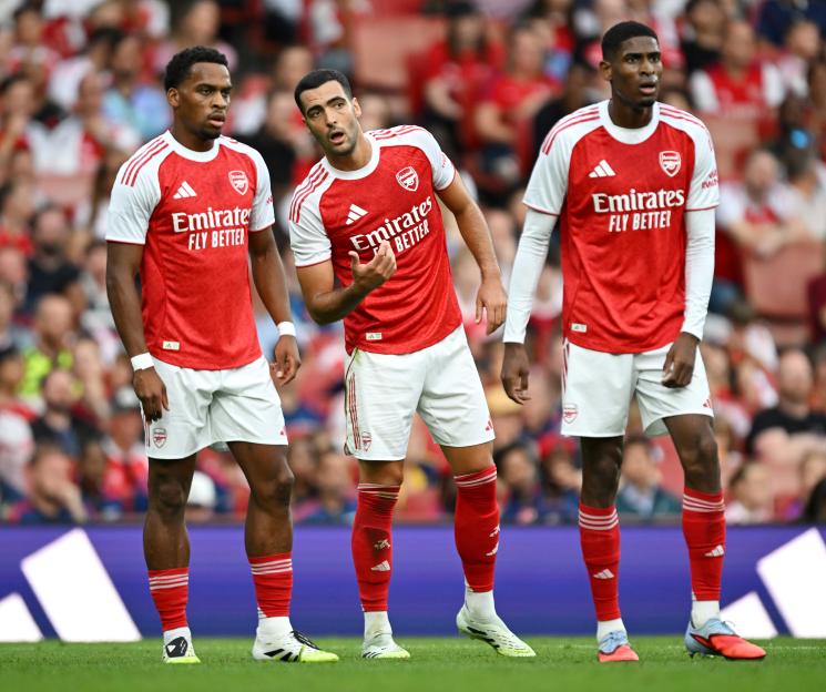 Mikel Merino and Jurrien Timber of Arsenal talking during a soccer match.