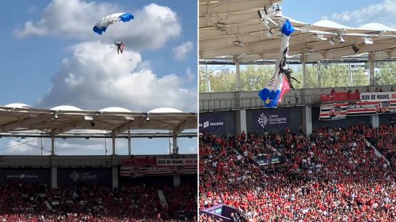 Horror moment parachutist crashes into stadium roof as he desperately clings on before fire engine races to rescue him