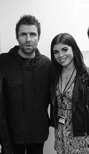 Black and white photo of Liam Gallagher with his three children.