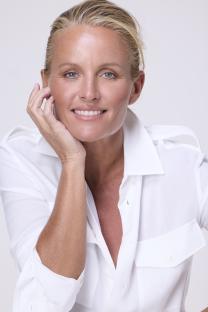 Portrait of Davinia Taylor wearing a white shirt.