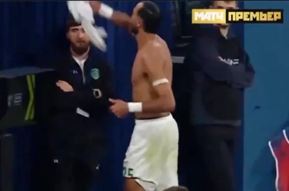 A soccer player throws a towel at an official.