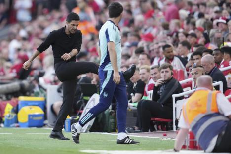 Mikel Arteta, Arsenal's manager, playfully kicks a ball.