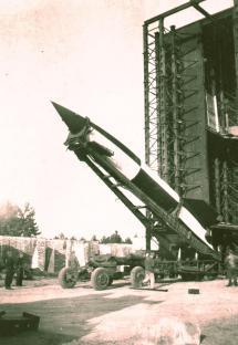 Black and white photo of a V2 rocket on a launchpad.
