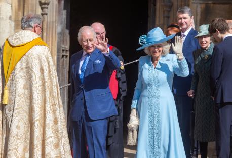 King Charles III and Queen Camilla waving to the crowd.