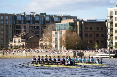 The Oxford and Cambridge men's rowing teams competing in the Gemini Boat Race on the River Thames.