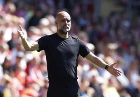 Pep Guardiola reacting during a soccer match.