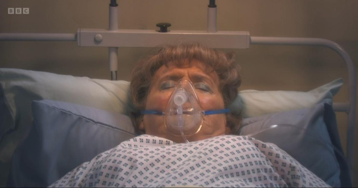 Agnes Brown in a hospital bed wearing an oxygen mask.