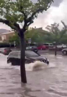 Car driving through flooded street in Porto Cristo, Majorca.