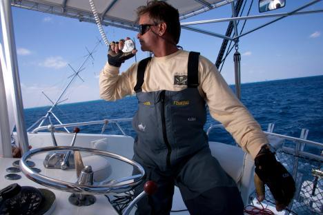 A man on a boat using a radio.