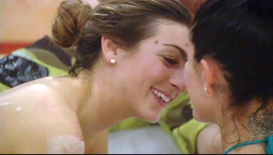 Luisa Zissman and Jasmine Waltz kissing in a hot tub.