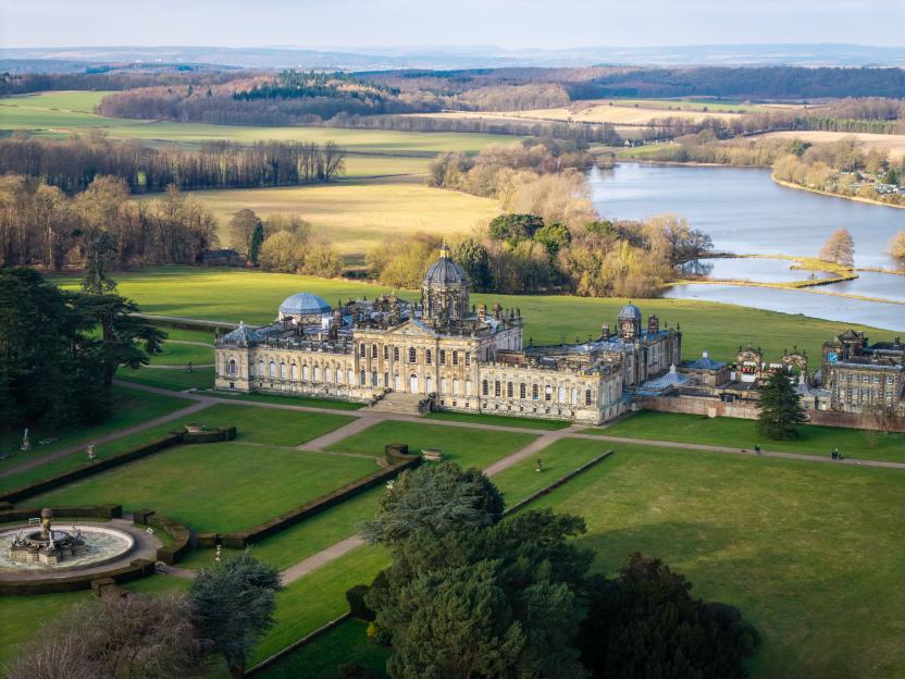 Aerial landscape panorama of Castle Howard stately home and gardens in the Howardian Hills with the Great Lake in the distance.