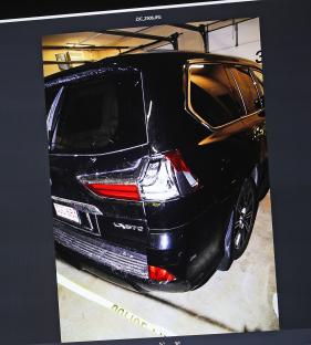 Photo of a damaged black SUV presented as evidence.