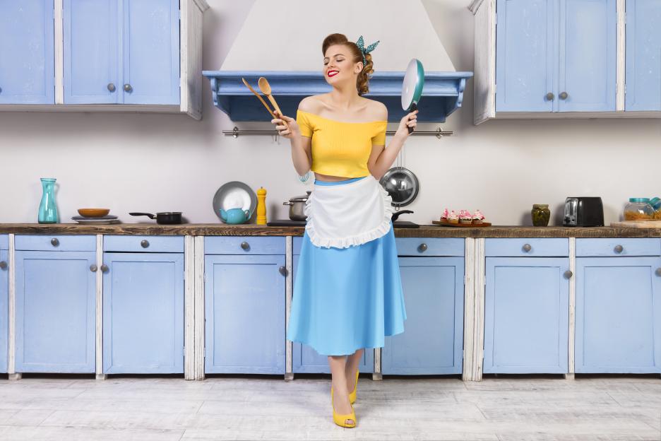 Retro pin housewife sitting in the kitchen