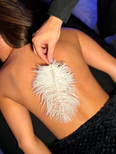 A white feather on a person's back.