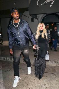 Khloe Kardashian and Tristan Thompson holding hands.