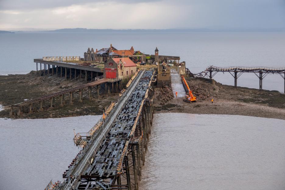 Repair work underway on a dilapidated pier.
