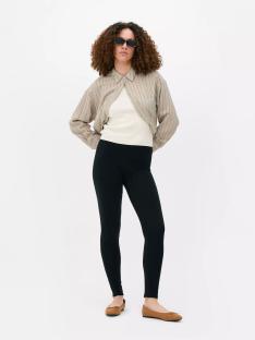 Woman wearing black leggings and a striped shirt.