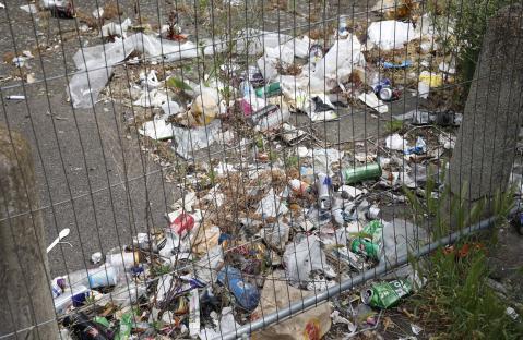 Litter behind a fence.