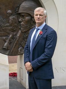 Alistair Carns OBE MC MP standing in front of the Iraq Afghanistan statue outside the Ministry of Defence.