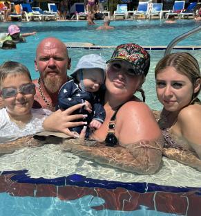 Family in a swimming pool.