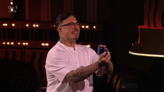Man holding a small blue ring box.