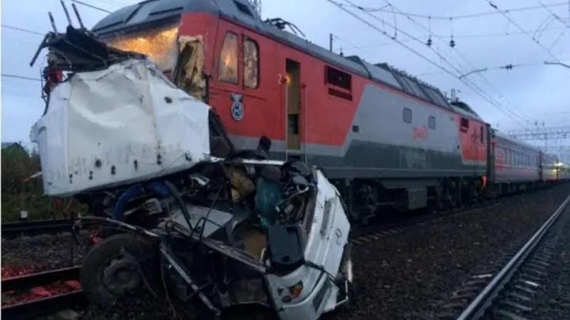 One dead, 11 injured after freight train collides with tourist bus
