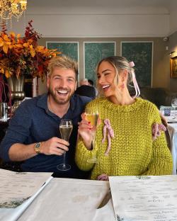 Smiling couple toasting with champagne in a restaurant.