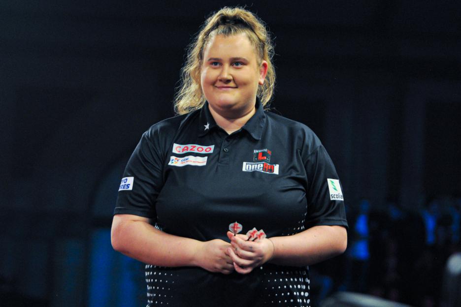 Beau Greaves of England looks on during her match at the 2022/23 Cazoo World Darts Championship.