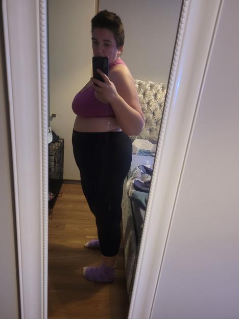 Woman taking a selfie in a mirror showing weight regain after Ozempic treatment.