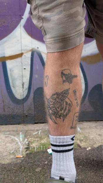 Person's lower leg with several tattoos.
