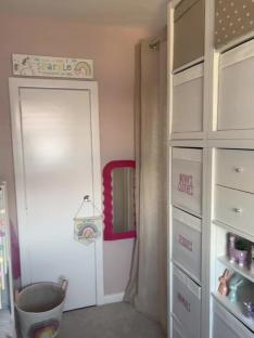 Two girls' bedroom divided by an IKEA storage unit.