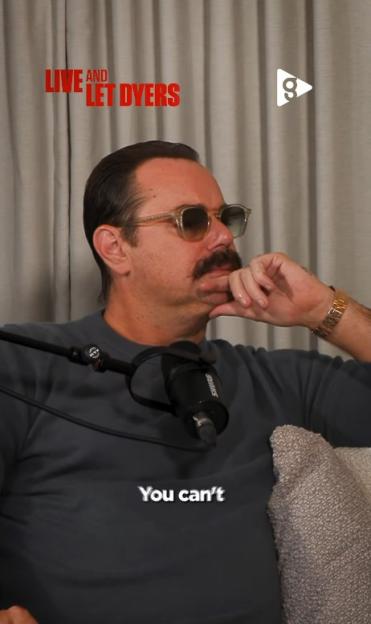 Man with mustache, sunglasses, and a gold watch sitting next to a microphone with text "LIVE and LET DYERS" and "You can't".
