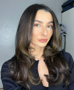 Portrait of a woman with long brown hair.