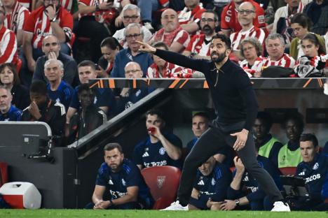 Manchester United's head coach instructing players from the sidelines.