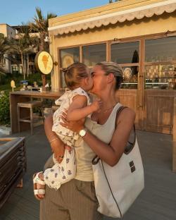 Woman kissing her toddler in Dubai.