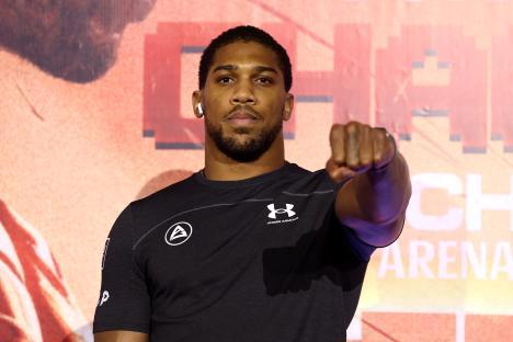 Anthony Joshua posing with a fist raised.