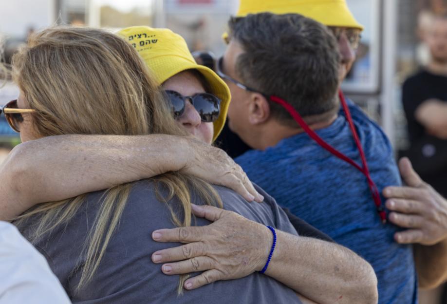 People embracing each other at a vigil on the second anniversary of the Nova Festival massacre.