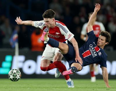 Declan Rice of Arsenal challenged by Joao Neves of Paris Saint-Germain during a soccer match.
